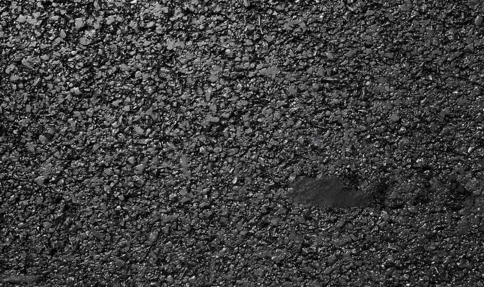 A perspective road photograph of a flawless, smooth black SBS modified asphalt highway surface stretching into the distance.