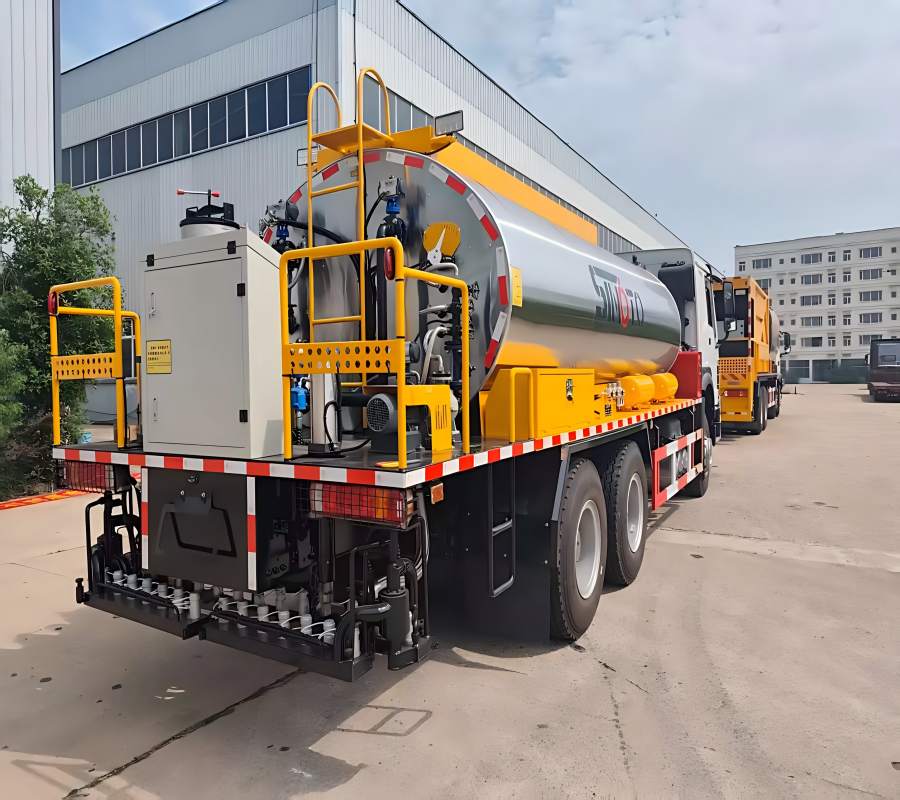 Rear view of a SINOTO asphalt distributor showing the hydraulic spray bar, precision nozzles, and rear lighting system for road surfacing.